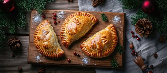 A couple of authentic gluten free alternative flour pies with potato filling are showcased on top of a wooden cutting board, representing National Karelian food.