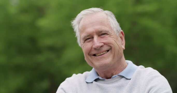 Senior man, outdoors and smile or face, relaxing and positivity in retirement, peace and garden. Elderly person, wellness and leisure in backyard, health and fresh air or calm, portrait and nature