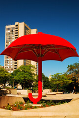 A red umbrella stands in the courtyard at the entrance to the Travelers Insurance building in Hartford Connecticut