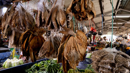 Smoked dried fish hanging on stall at fruit and vegetable market in capital city of Dili, Timor-Leste, Southeast Asia