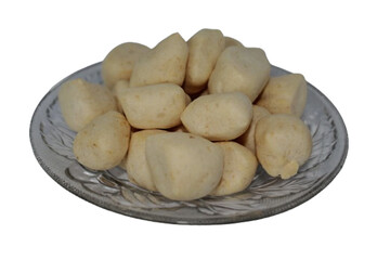 Amplang Kalimantan, an Indonesian crackers made from mackerel, on round plate. Isolated picture on white background.