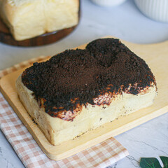 New chocolate-flavored milk bun on wood