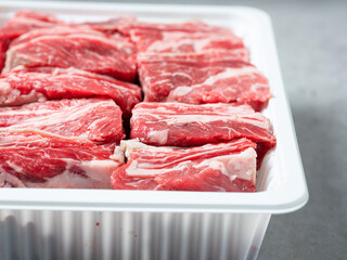 Fresh raw ribs in a packaging container