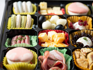 Various cheeses, raw ham, various dessert foods