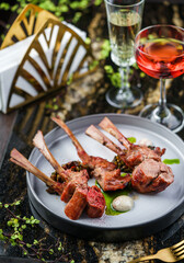 Tomahawk rib beef steak on bone with sauce on plate over marble background. Hot Meat Dishes, top view, selective focus