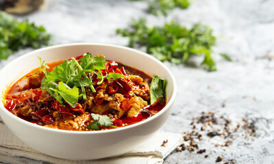 skewered vegetables and meat cooked in a hot and spicy soup