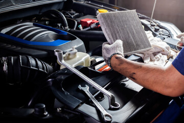 Car air conditioner system maintenance, Hand mechanic holding car air filter to check for clean dirty or fix repair heat have a problem or replace new or change filter. - obrazy, fototapety, plakaty