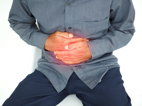 Man with stomach pain causes of abdominal pain include inflammatory bowel disease-IBD. stomach ulcer irritable bowel syndrome (IBS), ulcerative colitis and microvilli. Medical concept.