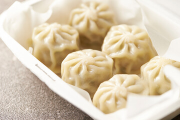 Steamed dumplings in a packaging container