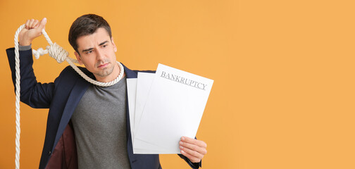 Stressed man with rope on neck and documents on color background. Bankruptcy concept