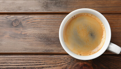 Cup of aromatic coffee on wooden table, top view. Space for text; menu photo; flat lay; close-up