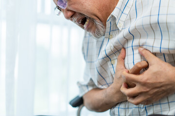 Asian senior older man having chest pain feel suffer from heart attack.