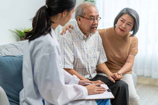 Asian caregiver nurse examine senior man and woman patient at home. 