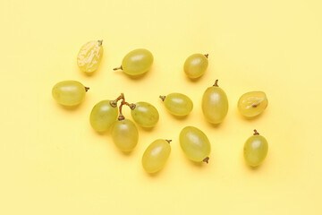 Fresh green grapes on yellow background
