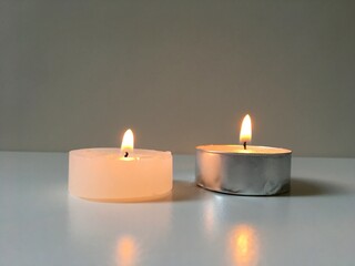 Obraz na płótnie Canvas Two burning candles in the dark