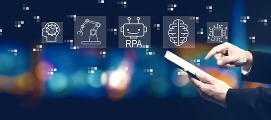 Robotic Process Automation RPA theme with businessman using a tablet computer at night