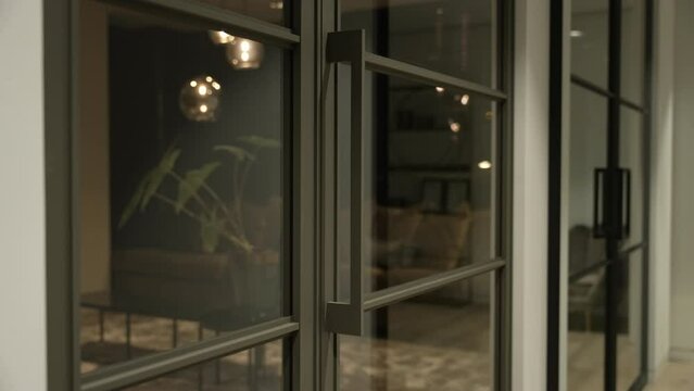 Modern glass office door slowly shutting closed in luxury apartment interior