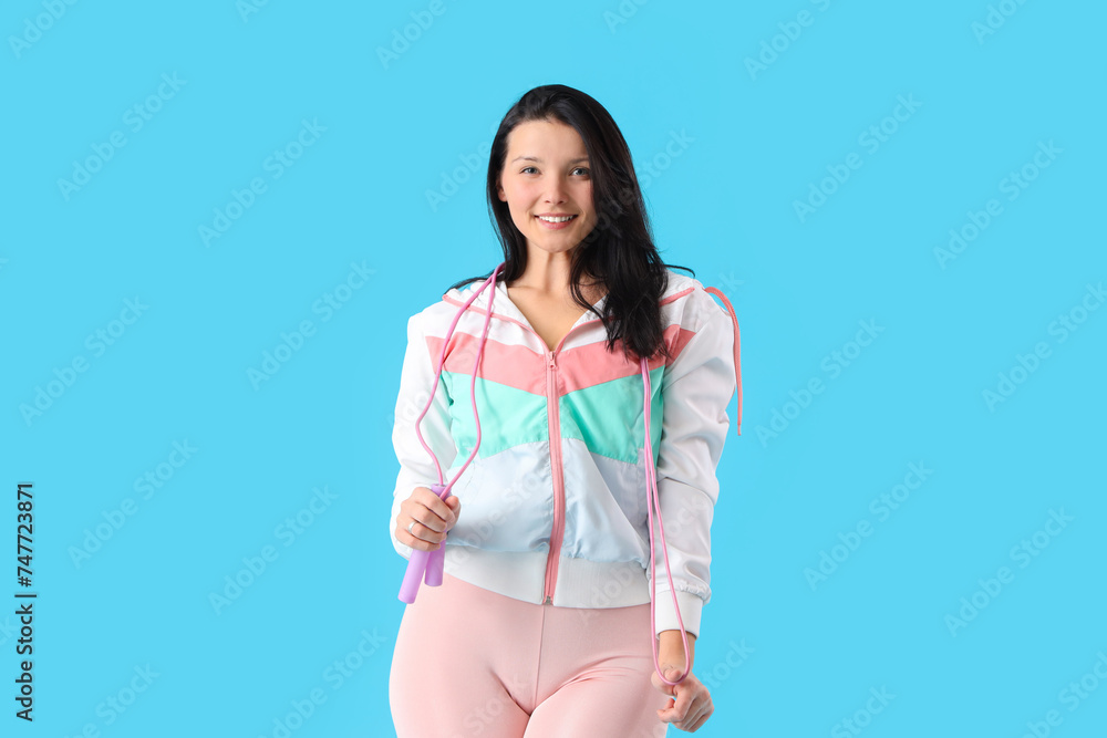 Sticker Sporty young woman with skipping rope on blue background