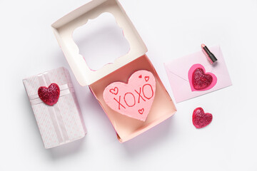 Heart-shaped bento cake with gift box and love letter on white background. Valentine's Day...