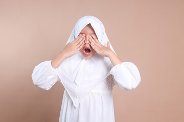Young Asian moslem student female rubbing her eye and yawning