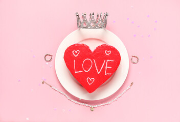 Heart-shaped bento cake with jewelry on pink background. Valentine's Day celebration