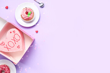 Heart-shaped bento cake with donut and cupcake on purple background. Valentine's Day celebration