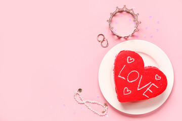 Heart-shaped bento cake with jewelry on pink background. Valentine's Day celebration