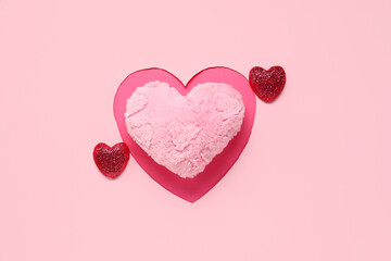 Composition with heart-shaped cushion and decor for Valentine's Day celebration on pink background