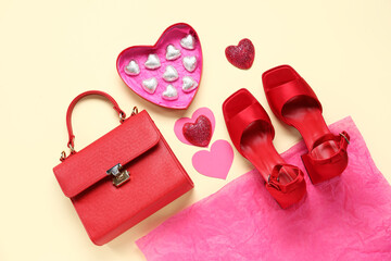 Composition with candies, shoes and handbag on color background. Valentine's Day celebration