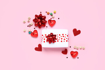 Composition with beautiful gift box, candles and decor on pink background. Valentine's Day...