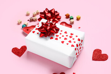 Composition with beautiful gift box, candles and decor on pink background. Valentine's Day...