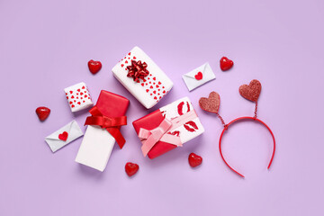 Fototapeta na wymiar Gift boxes with hearts and festive headband on lilac background. Valentine's Day celebration