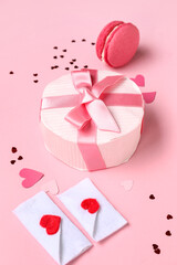Beautiful gift box with love letters and tasty macaroon on pink background. Valentines Day celebration