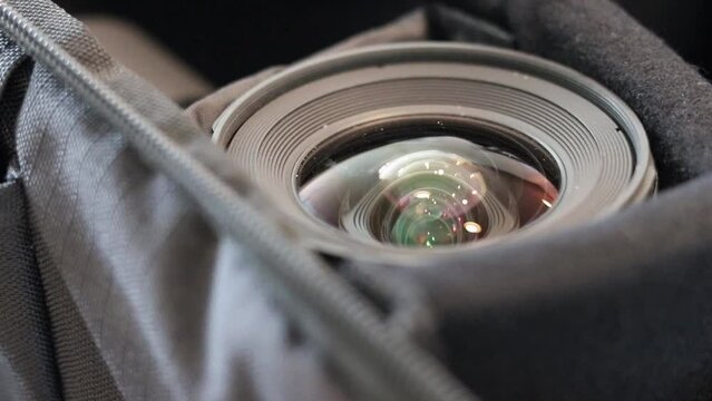 Close up shot of a Tokina 11-16mm f2.8 lens in a camera bag. Shot at 60FPS, slowed down to 24FPS. Shot on canon 80D with 50mm f1.8. STM.