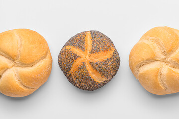 Delicious kaiser rolls on white background