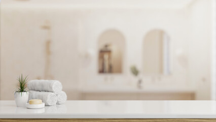 Toiletries and empty space on a white tabletop with a blurred background of a luxury bathroom.
