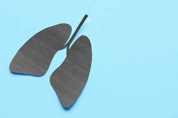 Black paper lungs on blue background