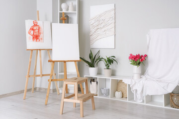Interior of artist's workshop with easels
