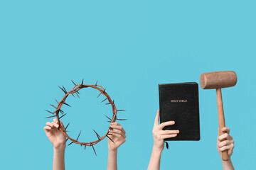 Female hands with crown of thorns, mallet and Holy Bible on color background. Good Friday concept