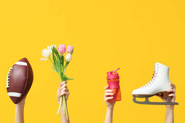 Female hands with sports equipment and tulip flowers for International Women's Day on yellow background - obrazy, fototapety, plakaty