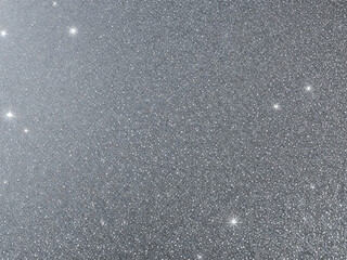 Blurred bokeh light on gray silver background. New Year holidays template. Abstract glitter defocused blinking stars and sparks.