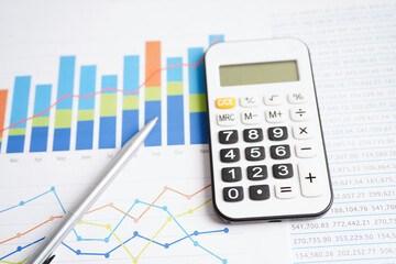 Calculator on chart graph paper. Finance, account, statistic, investment data economy, stock exchange business.