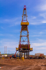 Fototapeta na wymiar oil and gas drilling rig on a summer sunny day against a blue sky