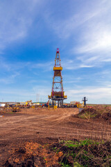 oil and gas drilling rig on a summer sunny day against a blue sky