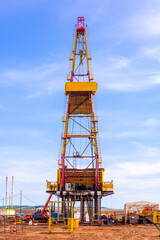 oil and gas drilling rig on a summer sunny day against a blue sky