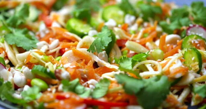 Coleslaw stock footage. Cabbage salad on a plate rotaing. Lunch bowl food. Wholefoods and vegetarian dishes. Healthy plant based vegan food. High resolution 4k cooking shallow depth of field footage.