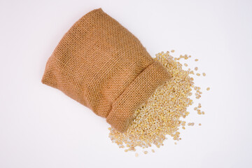 Dry pearl barley in the bag concept background