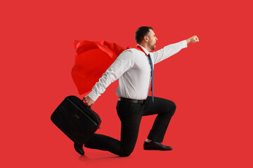 Businessman with superhero cape and briefcase flying on red background