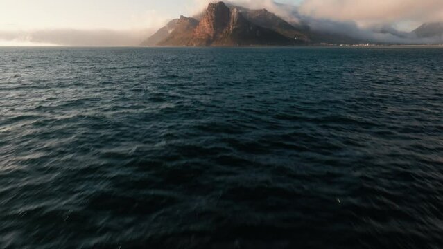 Cape Town's Sentinel Mountain Peak Peninsula. Aerial Tilt Up Reveal Shot