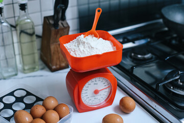 Weighing Flour for Baking on Scales at The Kitchen